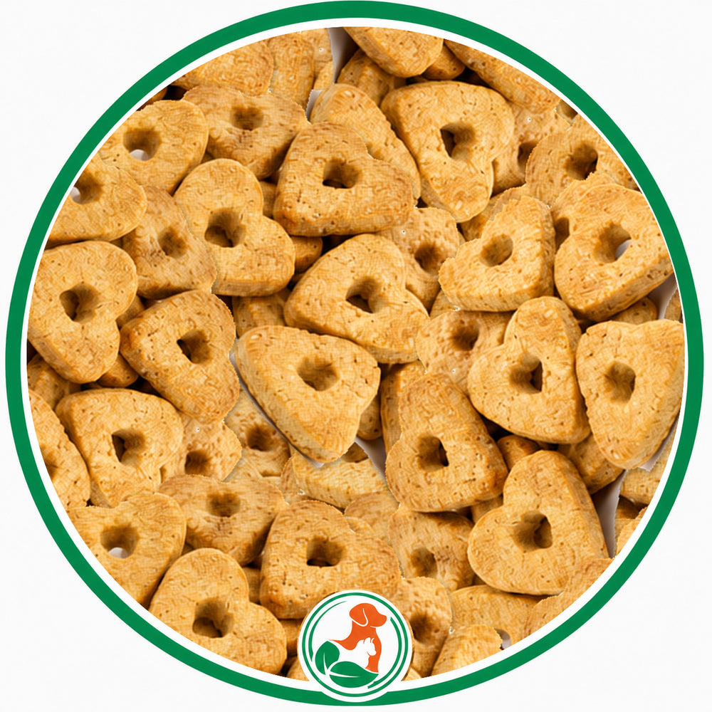 Golden Peanoat Hearts dog treats with small center holes in a green-bordered circular close-up.