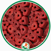 Ruby-red heart-shaped Ruby Cake Hearts dog treats with center holes in a green circular border.