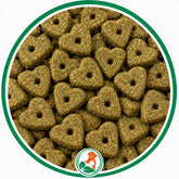 Olive-green heart-shaped Super Snacks dog treats with center holes in a green-bordered circle.