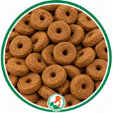Brown, ring-shaped Carrot Crunch Rounds dog treats with center holes in a green-bordered circle.