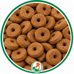 Brown, ring-shaped Carrot Crunch Rounds dog treats with center holes in a green-bordered circle.